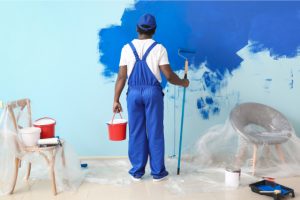 Worker Painting Wall in Room